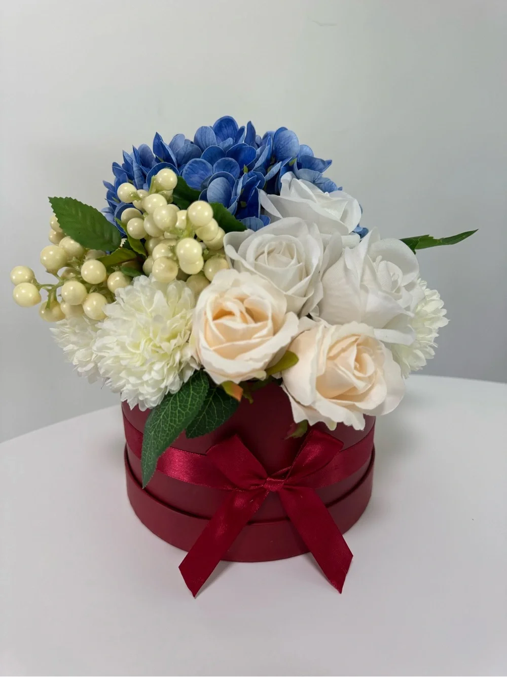 Artificial Floral Arrangement in Blue and Cream with Red Box